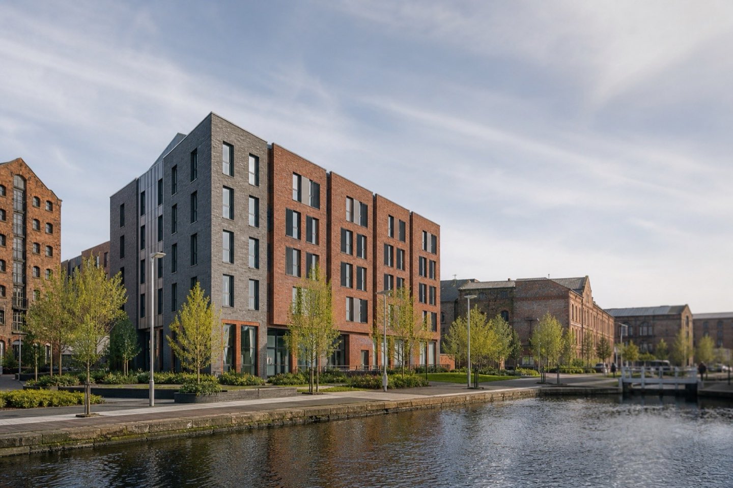 A brick student accommodation building beside a canal