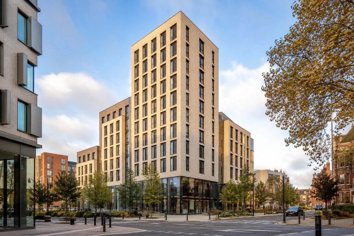 A contemporary brick student accommodation tower on a city street corner